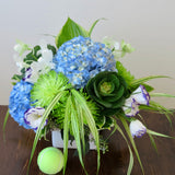 Flowers used: blue hydrangeas, purple/white lisianthus, white orchids, green chrysanthemums, hosta leaves and green kales