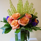 Flowers used: orange roses, yellow eremurus, purple lisianthus