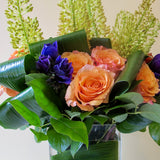 Flowers used: orange roses, yellow eremurus, purple lisianthus