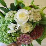 Flowers used: white roses, white lilies, white sedums, green chrysanthemums, green hydrangeas, pink sedums