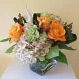Flowers used: orange roses, white calla lilies, mauve hydrangeas, hypericum berries