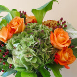 Flowers used: orange roses, green calla lilies, green hydrangeas, hypericum berries