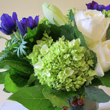 Flowers used: white roses, blue anemones, white amaryllis, green hydrangeas, red hypericum berries