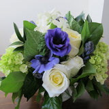 Flowers used: cream white roses, blue anemones, purple hyacinths, white orchids