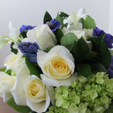 Flowers used: cream white roses, blue anemones, purple hyacinths, white orchids