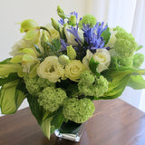 Flowers used: white roses, green viburnum, chartreuse cymbidium orchids, blue agapanthus