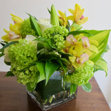 Flowers used: white roses, green viburnum, white lilies, yellow orchids