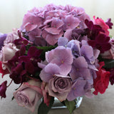 Flowers used: mauve roses, mauve hydrangeas, burgundy orchids, pink roses