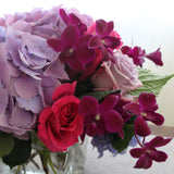 Flowers used: mauve roses, mauve hydrangeas, burgundy orchids, pink roses