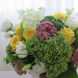 Flowers used: green hydrangeas, yellow roses, white lisianthus, white orchids, pink sedums, green kales