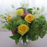 Flowers used: green hydrangeas, yellow roses, white lisianthus, white orchids, pink sedums, green kales