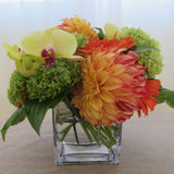 Flowers used: orange dahlias, orange gerberas, yellow cymbidium orchids, green hydrangeas