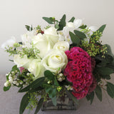 Flowers used: white roses, white orchids, pink celosias, seeded eucalyptus, white berries