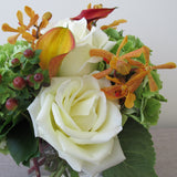 Flowers used: white roses, orange calla lilies, orange mokara orchids, green hydrangeas, hypericum berries