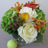 Flowers used: white roses, orange calla lilies, orange mokara orchids, green hydrangeas, hypericum berries
