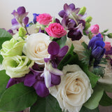 Flowers used: cream white roses, white gerberas, chartreuse lisianthus, blue anemones, pink mini roses, purple orchids