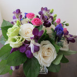 Flowers used: cream white roses, white gerberas, chartreuse lisianthus, blue anemones, pink mini roses, purple orchids