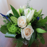 Flowers used: cream roses, white lilies, green chrysanthemums, blue irises