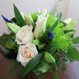 Flowers used: cream roses, white lilies, green chrysanthemums, blue irises
