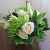 Flowers used: cream roses, white lilies, green chrysanthemums, blue irises