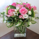Flowers used: pink roses, white freesias, white lisianthus, hosta leaves