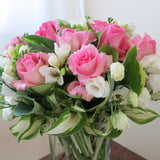 Flowers used: pink roses, white freesias, white lisianthus, hosta leaves