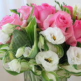 Flowers used: pink roses, white freesias, white lisianthus, hosta leaves