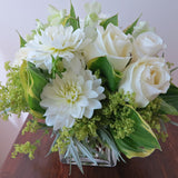 Flowers used: white roses, white dahlias, white orchids, chartreuse lady's mantle, hosta leaves