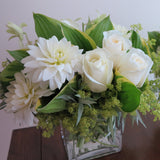 Flowers used: white roses, white dahlias, white orchids, chartreuse lady's mantle, hosta leaves