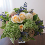 Flowers used: green hydrangeas, cream roses, white dahlias, blue spirea, pink sedums, hosta leaves