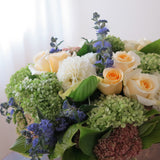 Flowers used: green hydrangeas, cream roses, white dahlias, blue spirea, pink sedums, hosta leaves