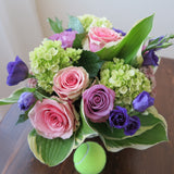 Flowers used: green hydrangeas, pink and mauve roses, blue lisianthus, pink sedums, hosta leaves