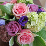 Flowers used: green hydrangeas, pink and mauve roses, blue lisianthus, pink sedums, hosta leaves