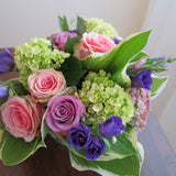 Flowers used: green hydrangeas, pink and mauve roses, blue lisianthus, pink sedums, hosta leaves