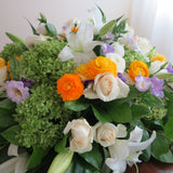 Flowers used: cream roses, white lilies, green hydrangeas, white ranunculus and purple lisianthus