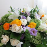 Flowers used: cream roses, white lilies, green hydrangeas, white ranunculus and purple lisianthus