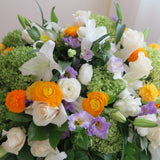 Flowers used: cream roses, white lilies, green hydrangeas, white ranunculus and purple lisianthus