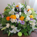 Flowers used: cream roses, white lilies, green hydrangeas, white ranunculus and purple lisianthus