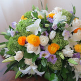 Flowers used: cream roses, white lilies, green hydrangeas, white ranunculus and purple lisianthus