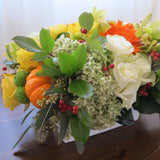 Flowers used: yellow roses, orange gerberas and gourds, green mums, orchids and hydrangeas, red rose hips and chartreuse seeded eucalyptus