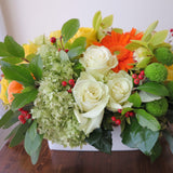 Flowers used: yellow roses, orange gerberas and gourds, green mums, orchids and hydrangeas, red rose hips and chartreuse seeded eucalyptus