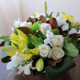 Flowers used: yellow lilies, green chrysanthemums, white roses, white orchids, white lisianthus