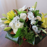 Flowers used: yellow lilies, green chrysanthemums, white roses, white orchids, white lisianthus