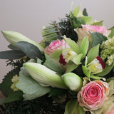 Flowers used: chartreuse cymbidium orchids, white amaryllis, pink roses, green hydrangeas, white hypericum berries
