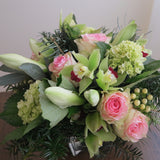 Flowers used: chartreuse cymbidium orchids, white amaryllis, pink roses, green hydrangeas, white hypericum berries