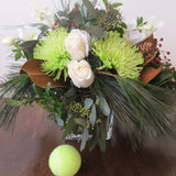 Flowers used: white orchids and white roses, green chrysanthemums, magnolia leaves, seeded eucalyptus, white pine