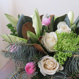 Flowers used:  white roses, green chrysanthemums, magnolia leaves, white amaryllis, pink ranunculus, evergreens
