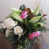 Flowers used:  white roses, green chrysanthemums, magnolia leaves, white amaryllis, pink ranunculus, evergreens