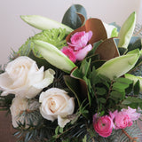Flowers used:  white roses, green chrysanthemums, magnolia leaves, white amaryllis, pink ranunculus, evergreens