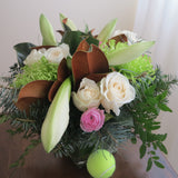 Flowers used:  white roses, green chrysanthemums, magnolia leaves, white amaryllis, pink ranunculus, evergreens